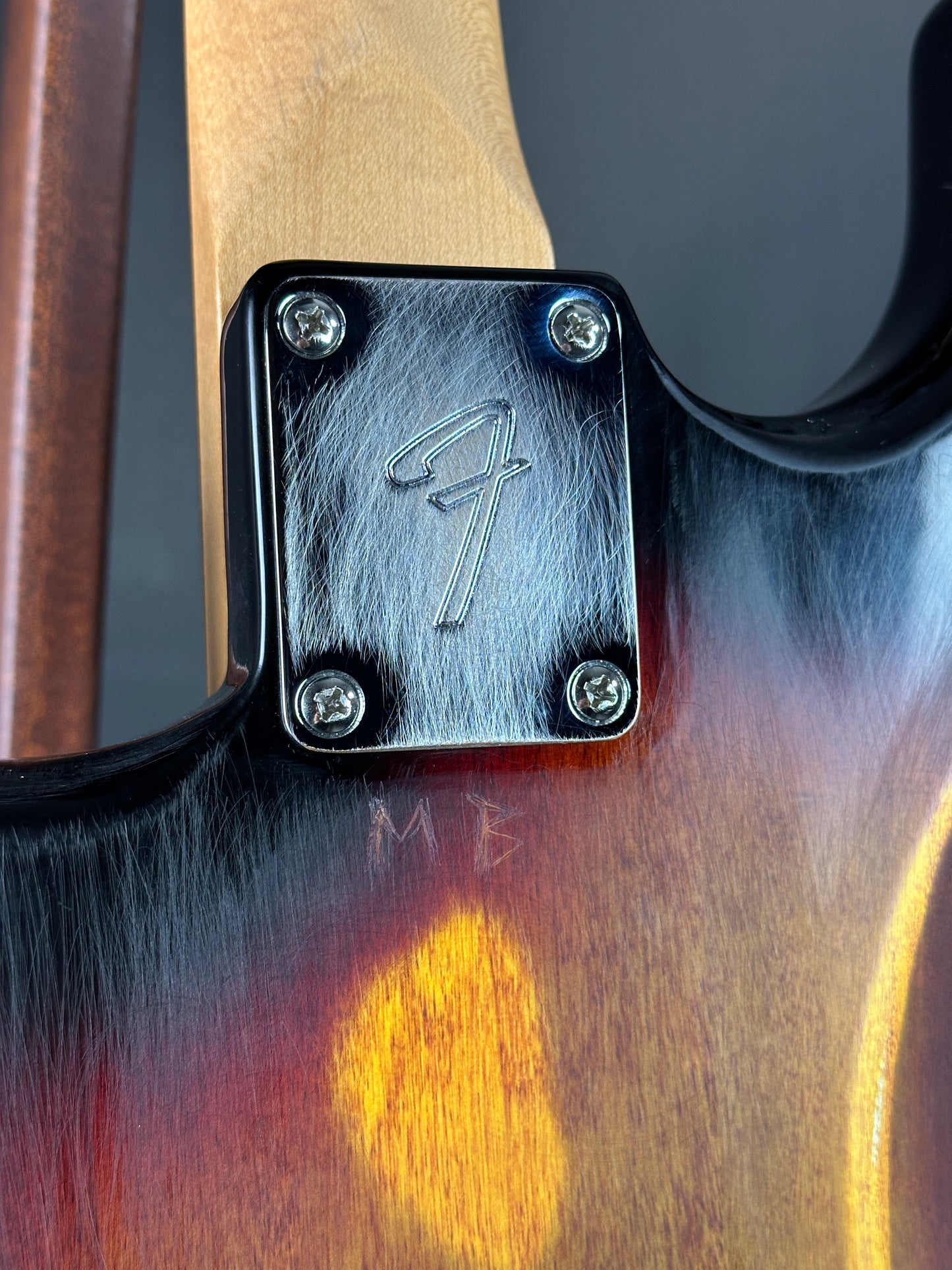 Close-up of a metallic plaque with engraved design on a wooden surface