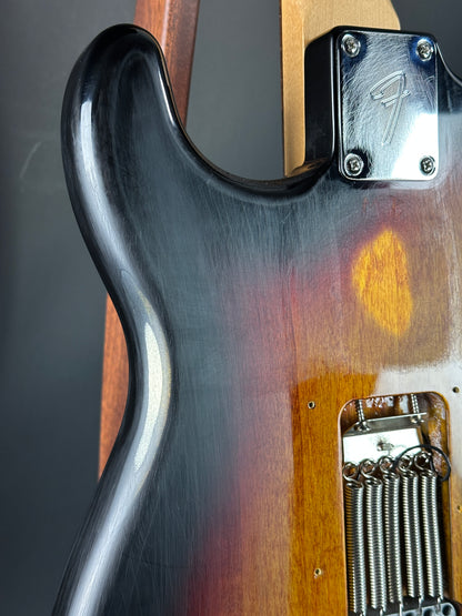 Close-up of a guitar's neck and headstock with a visible brand logo.