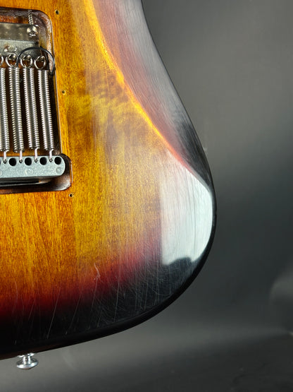Close-up of a guitar's wood finish and hardware