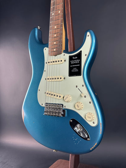 Blue electric guitar with a Fender logo on a dark background