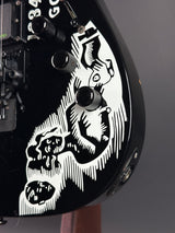 Close-up of a motorcycle dashboard with intricate white design on a black background