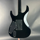 Black electric guitar on a gray background