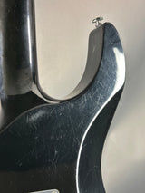 Close-up of a metal tool with a screw on a reflective surface