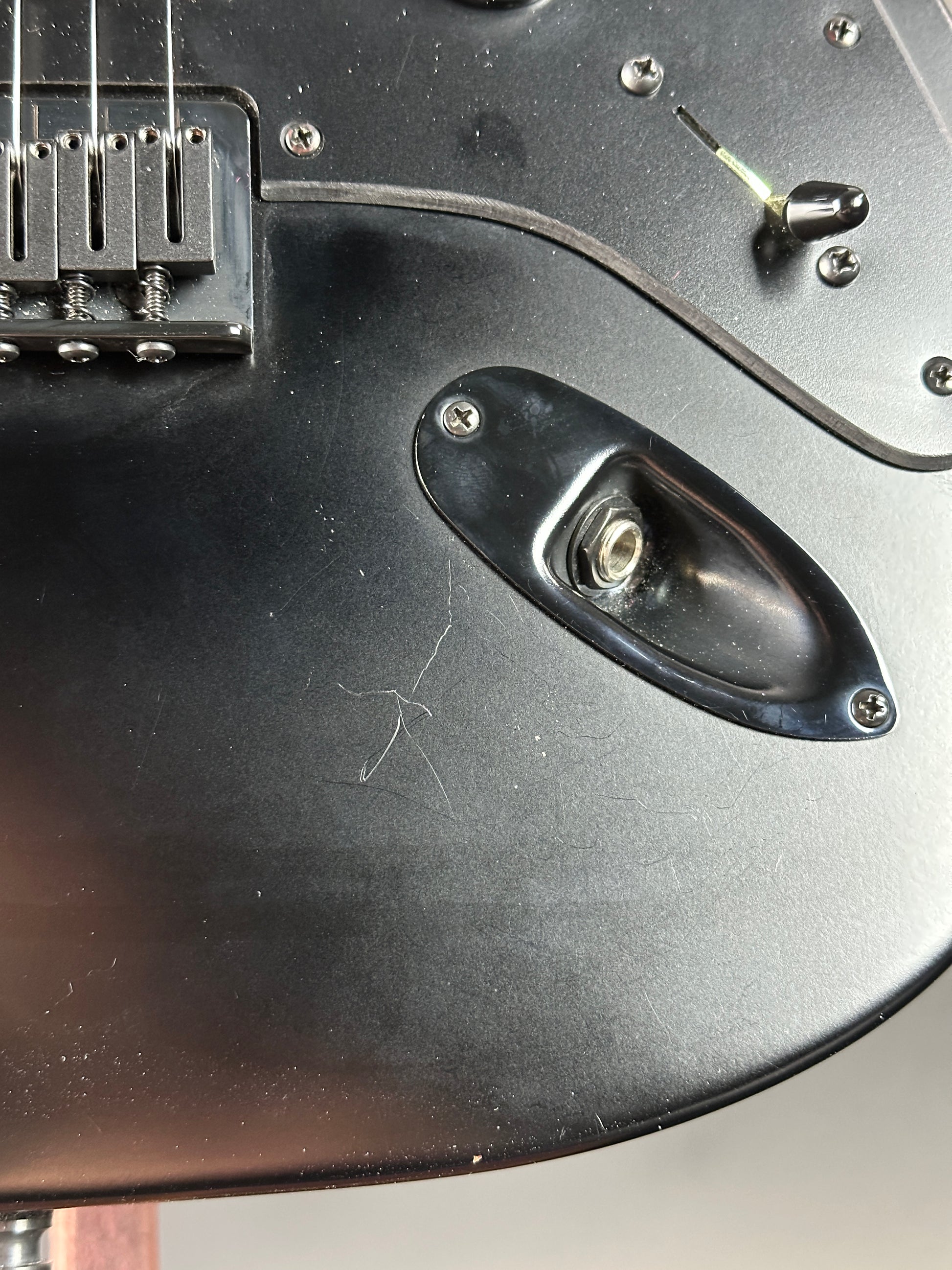 Scratch near output jack of Used Fender Jim Root Signature Strat.