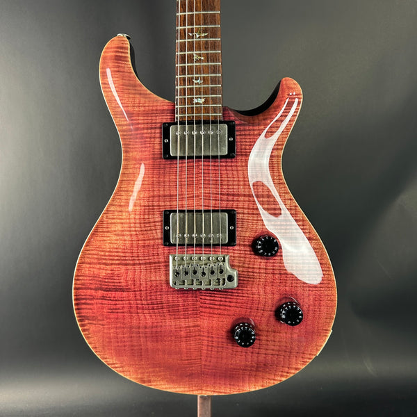 Glossy electric guitar with flame pattern on a dark gray background