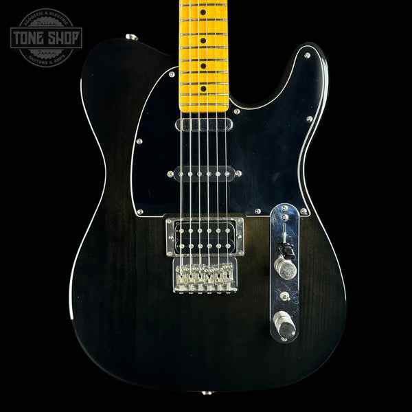 A black electric guitar with a yellow maple neck, featuring a black pickguard, chrome hardware, and a visible Tone Shop logo in the top-left corner.