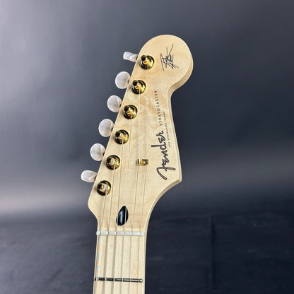 Close-up of a Fender guitar headstock on a dark background