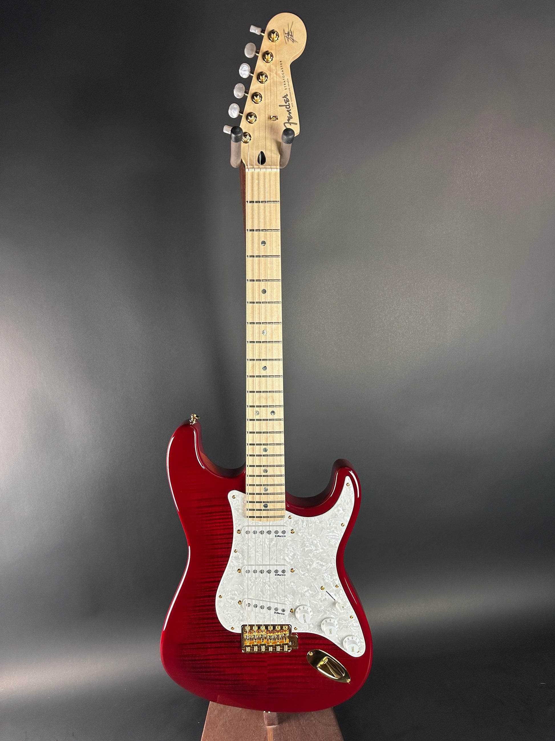 Red electric guitar on a gray background