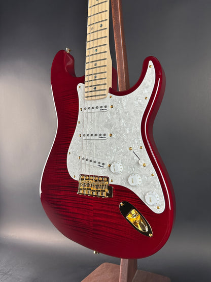 Red electric guitar on a gray background