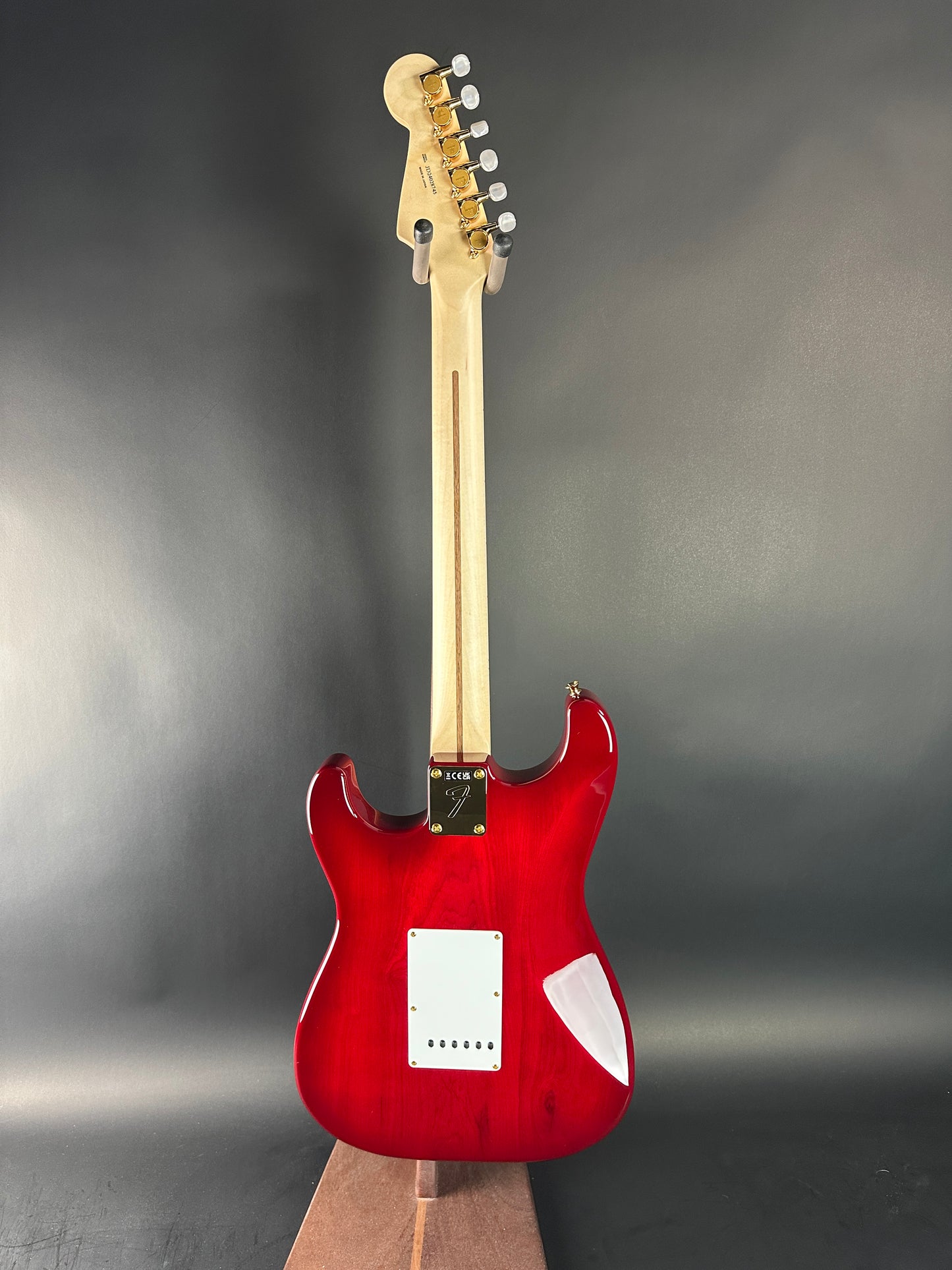 Red electric guitar on a gray background