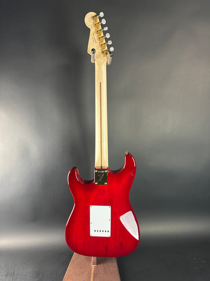 Red electric guitar on a gray background