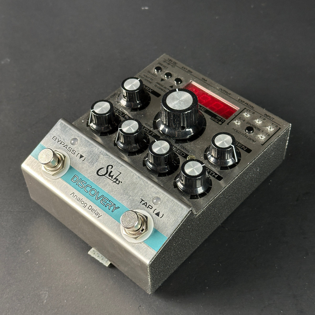 Guitar effects pedal with various knobs and labels on a dark background