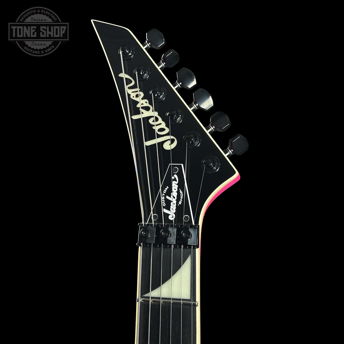 Front of headstock of Jackson Custom Shop TSG Illuminati SL2H FR  Neon Pink J11328.