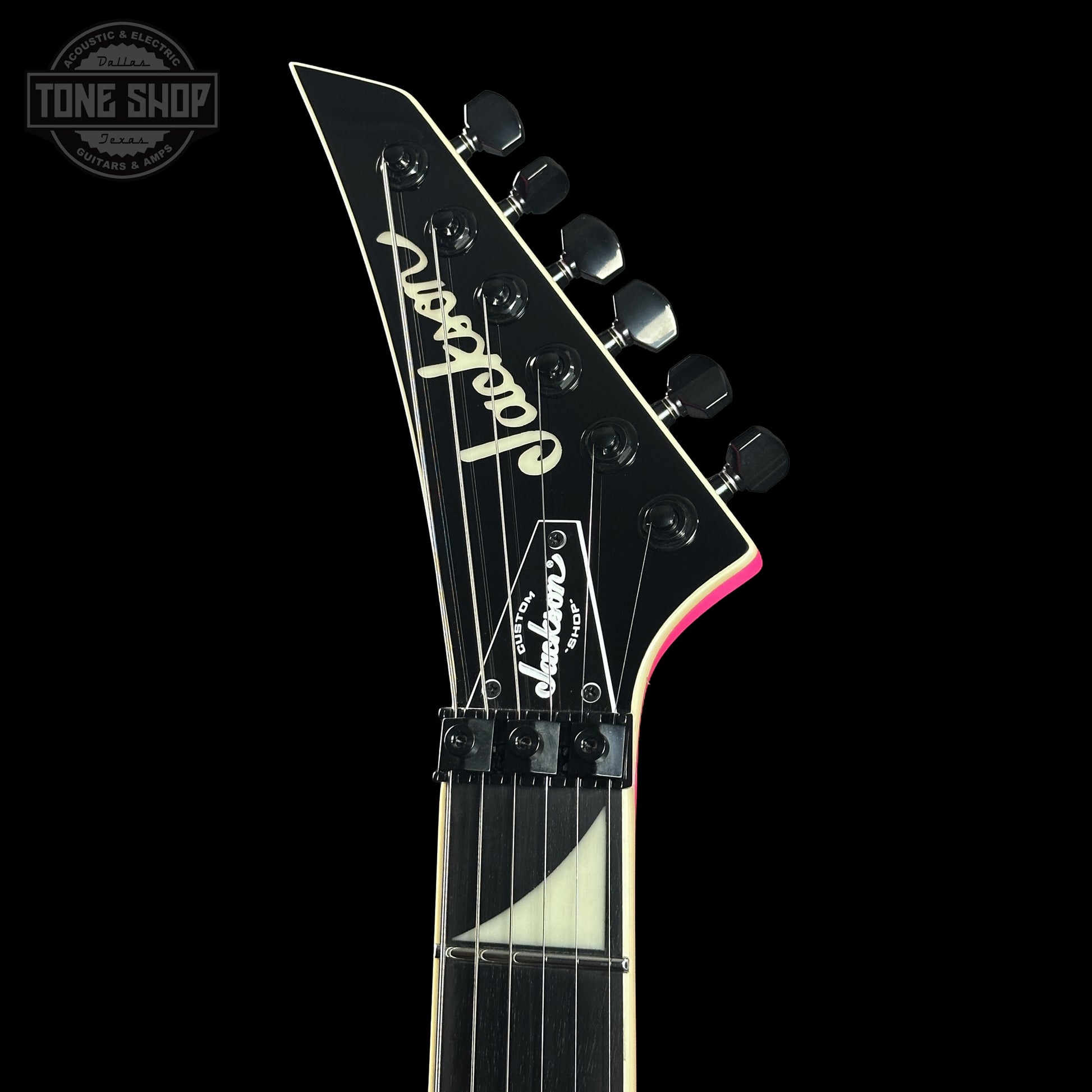 Front of headstock of Jackson Custom Shop TSG Illuminati SL2H FR  Neon Pink J11328.