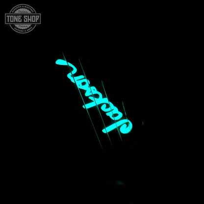 Headstock glowing in the dark of Jackson Custom Shop TSG Illuminati SL2H FR Vanilla Shake wcase J11274.