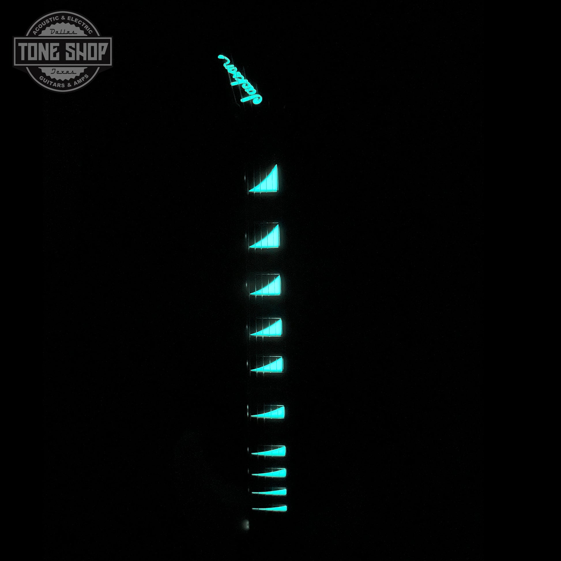 Front of neck and headstock glowing in the dark of Jackson Custom Shop TSG Illuminati SL2H FR Vanilla Shake wcase J11274.
