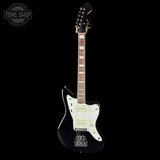 Electric guitar with a black and white design on a black background, featuring 'Tone Shop' branding.