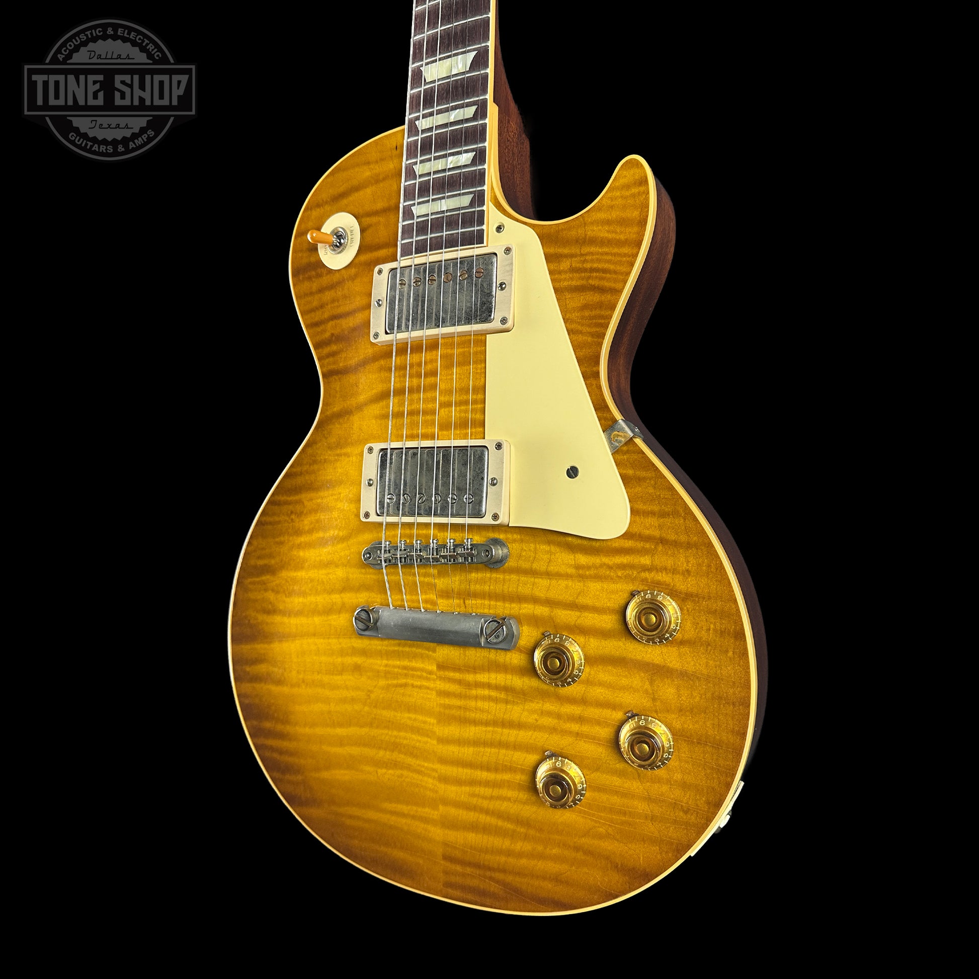 Electric guitar with a sunburst finish on a black background, featuring the Tone Shop logo.