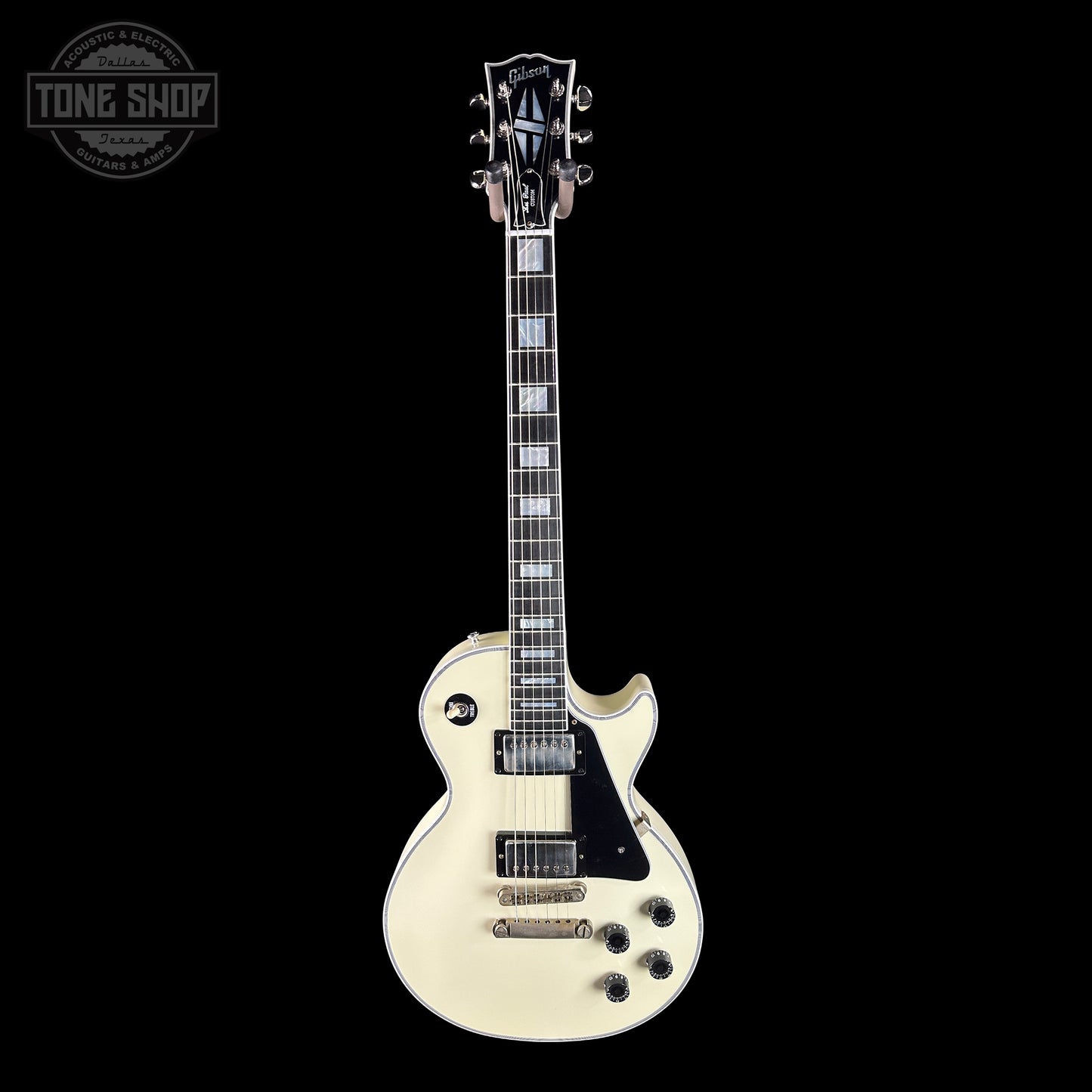 White electric guitar with black accents on a white background, featuring the Gibson logo.