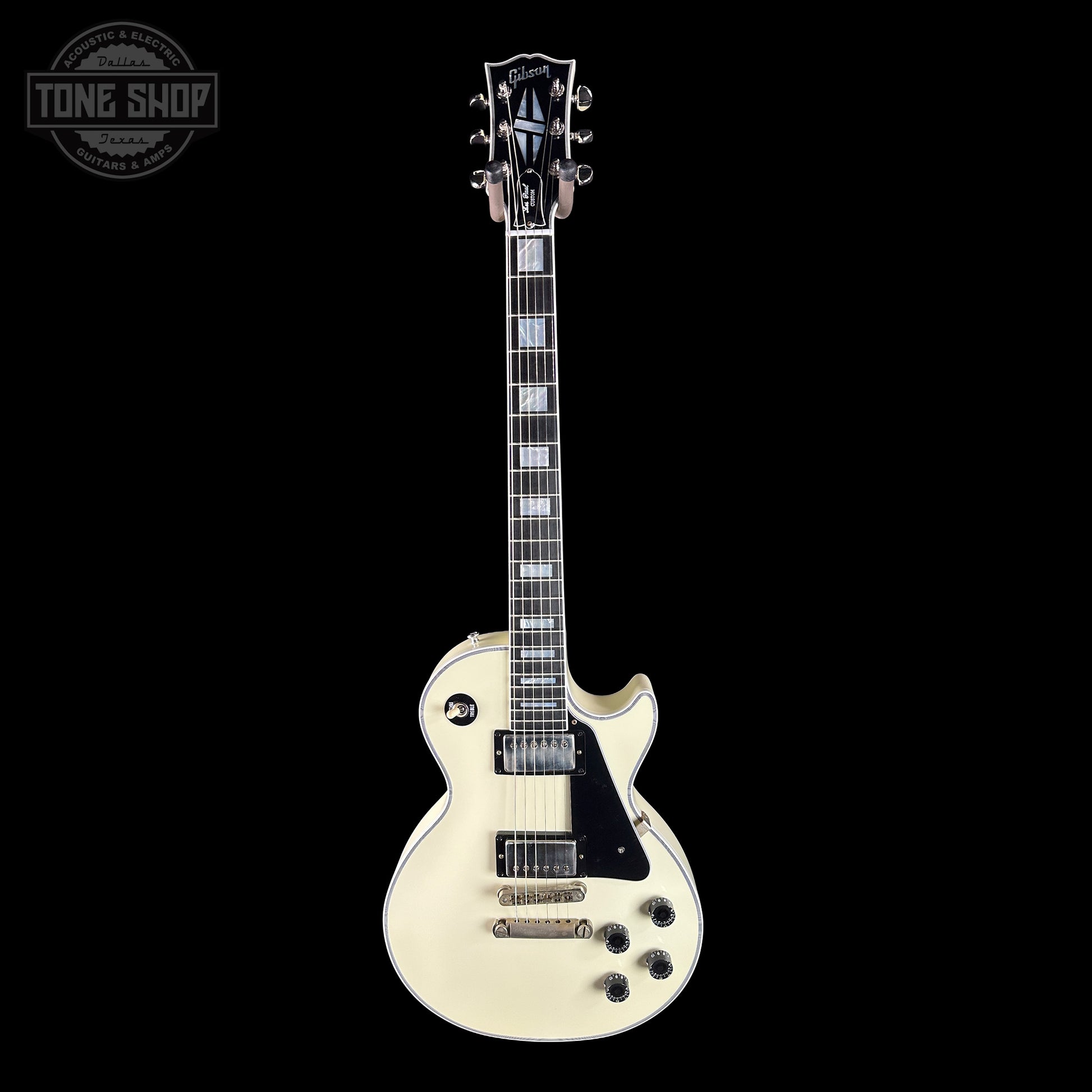 White electric guitar with black accents on a white background, featuring the Gibson logo.