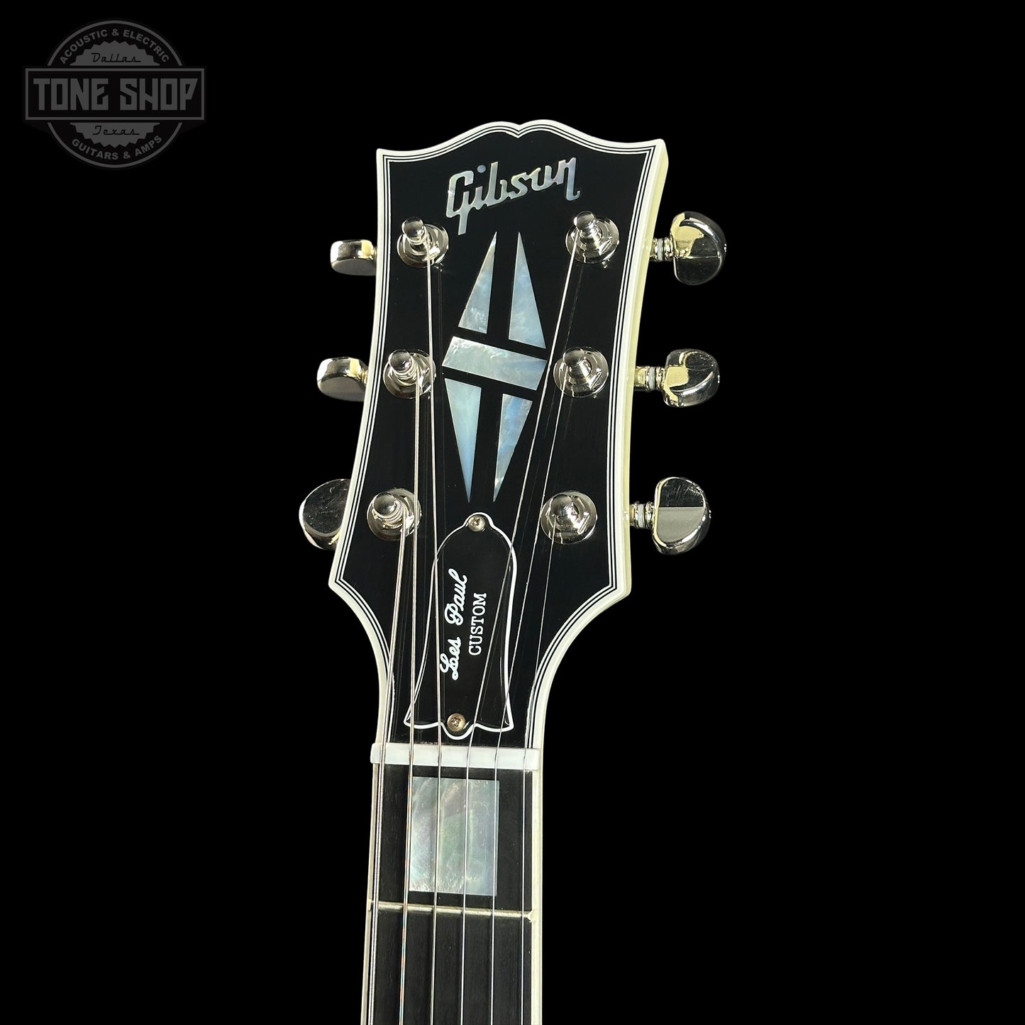 Gibson Les Paul Custom guitar headstock on a black background