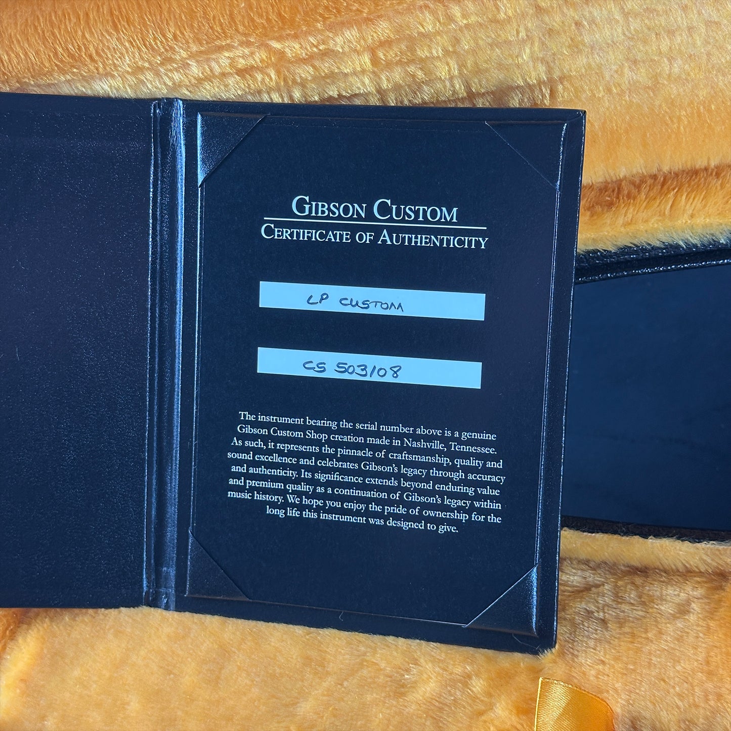 Gibson Custom Certificate of Authenticity on a wooden surface