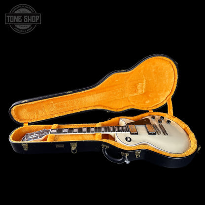 Electric guitar in an open case with 'Tone Shop' logo in the corner.