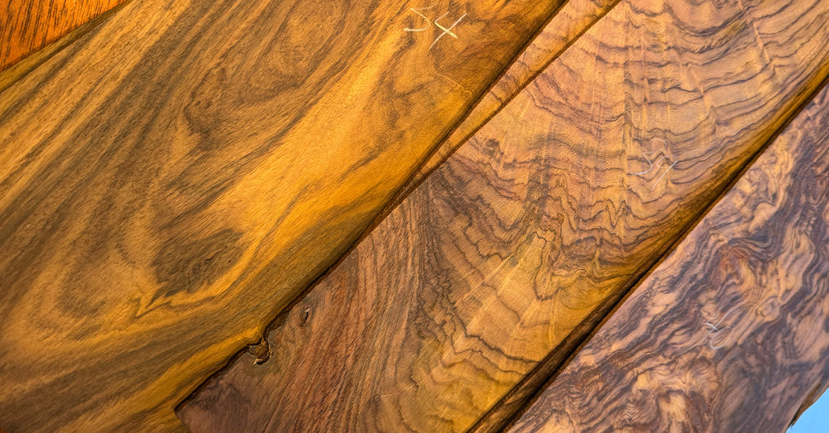 Multiple stacks of figured wood with rich grain figures.