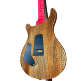 Wooden electric guitar with pink strings on a white background