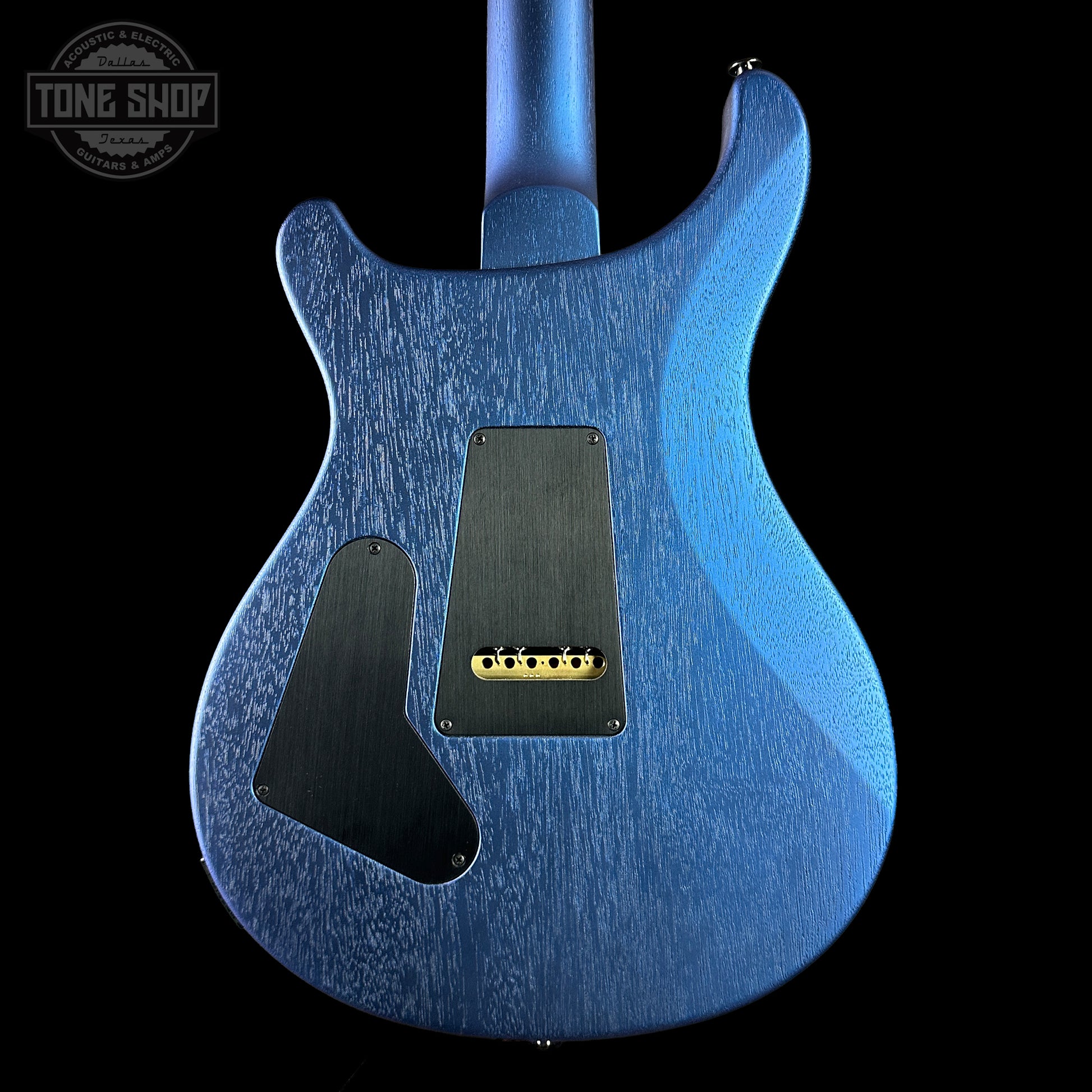 Blue electric guitar body with a visible brand logo in the corner.