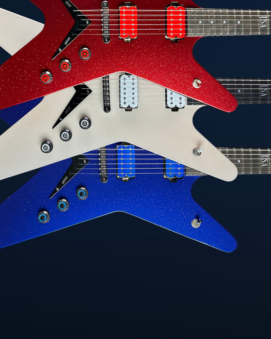 A group of three guitars, one red, one white, one blue, against a blue background with "labor day sale" text above.