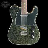 Green glittery electric guitar on a black background with 'Tone Shop' logo.