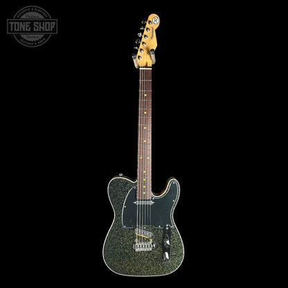 Electric guitar with a textured body on a black background, featuring the Tone Shop logo.