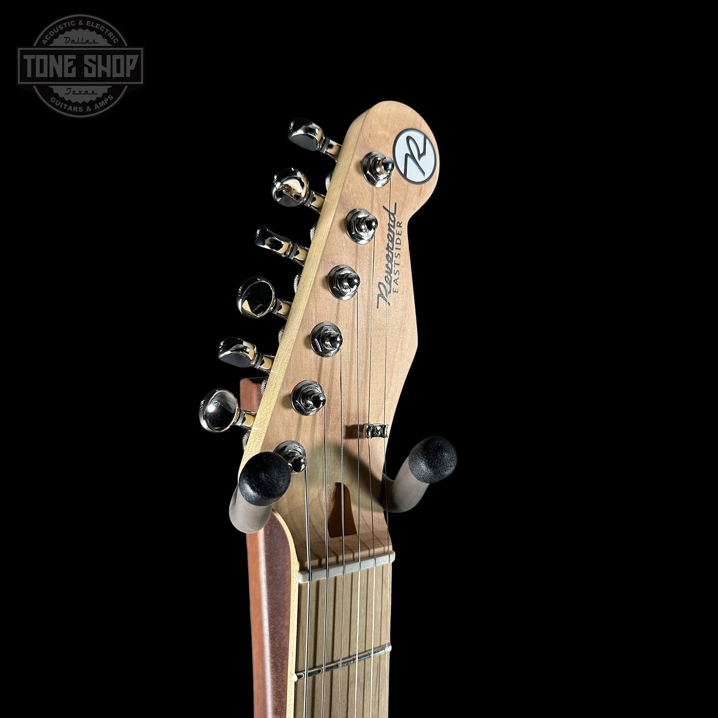 Guitar headstock with brand logo on a black background