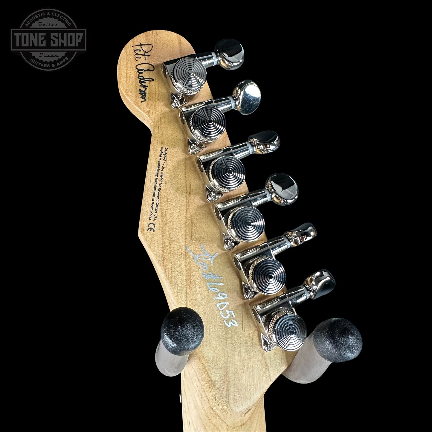 Guitar headstock with tuning pegs on a black background, featuring 'Tone Shop' branding.