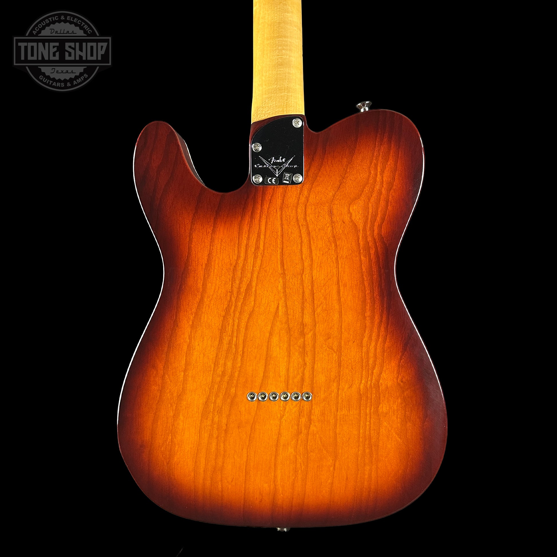Electric guitar body with a sunburst finish on a black background, featuring the Tone Shop logo.