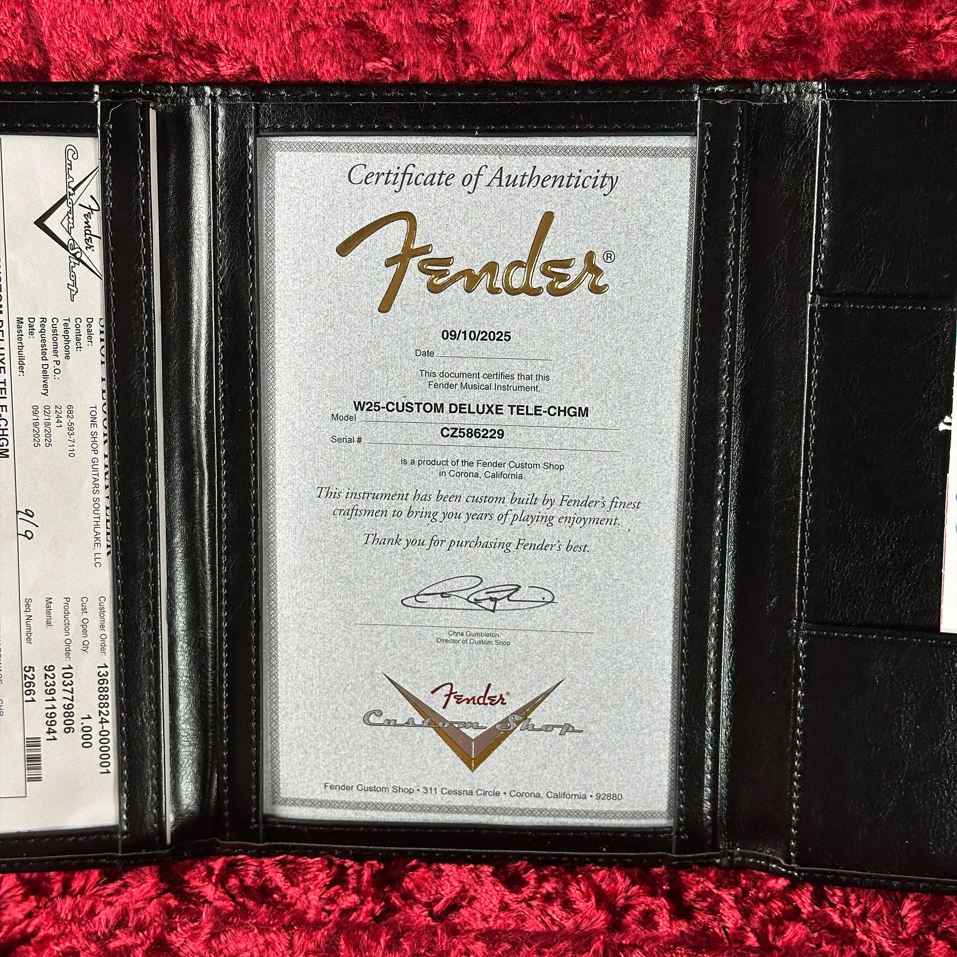 Fender Certificate of Authenticity in a black leather case on a red background