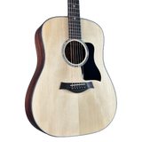 Acoustic guitar with a wooden body and dark fretboard on a white background