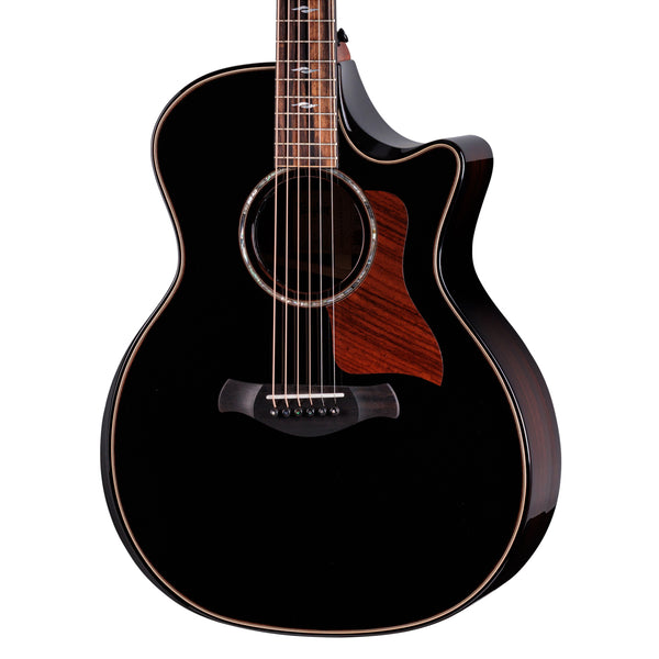Black acoustic guitar with a wooden soundboard on a white background