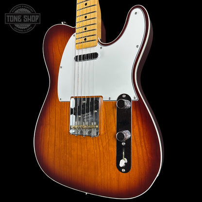 Electric guitar with a sunburst finish on a black background, featuring the Tone Shop logo.