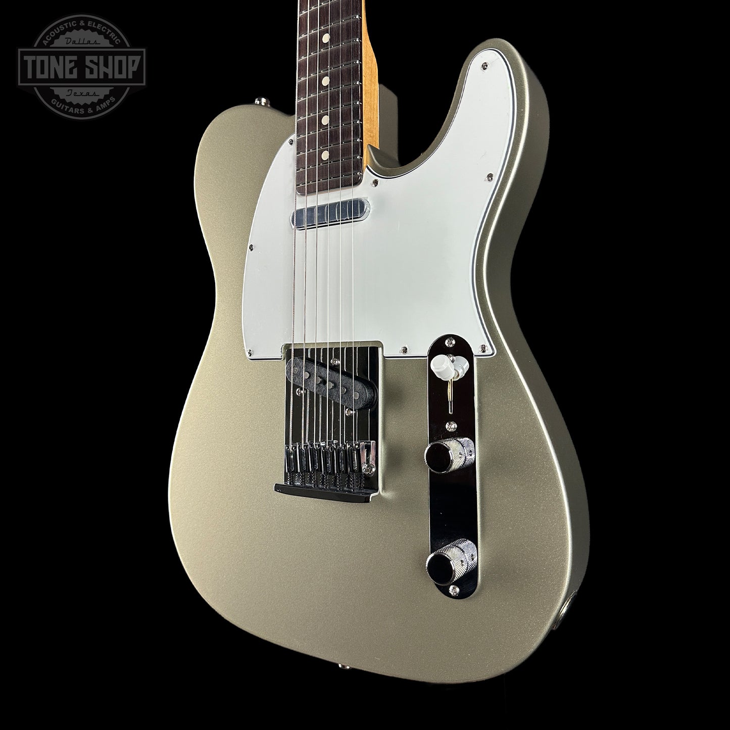 Electric guitar with a metallic finish on a black background, featuring the Tone Shop logo.