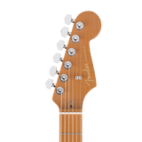 Close-up of a Fender Stratocaster guitar headstock in a natural wood finish, showing six silver tuning pegs and the Fender branding.