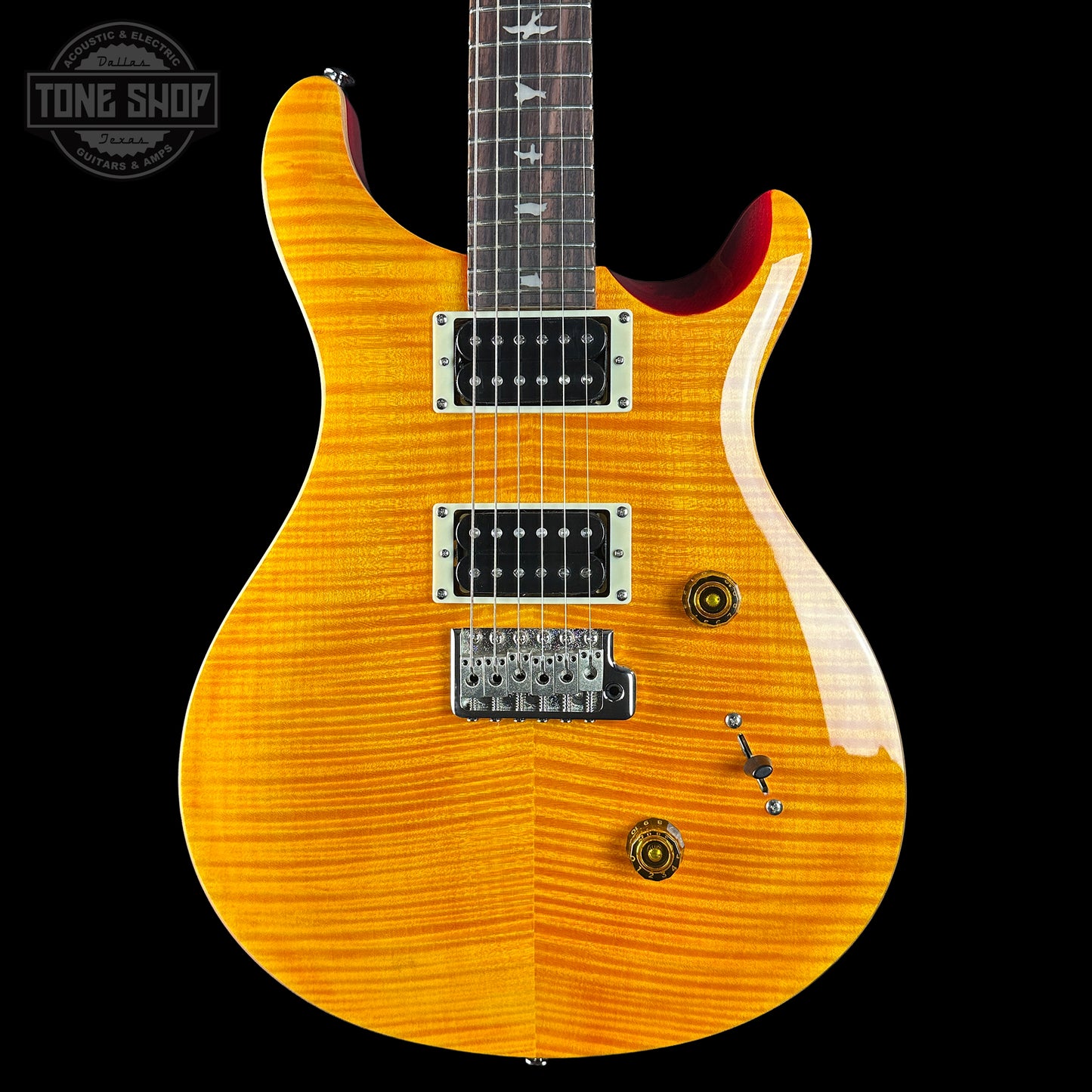 Electric guitar with a sunburst finish on a black background, featuring the Tone Shop logo.