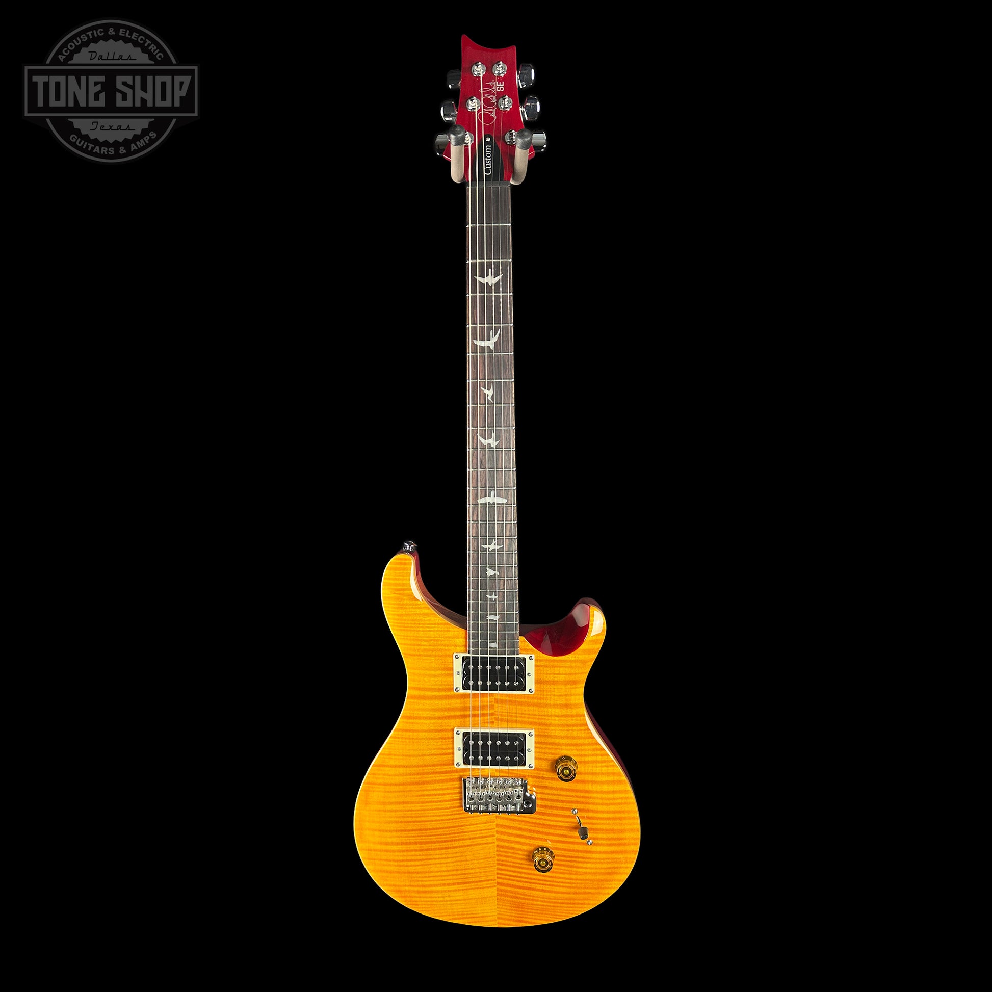 Electric guitar with a sunburst finish on a black background, featuring the Tone Shop logo.