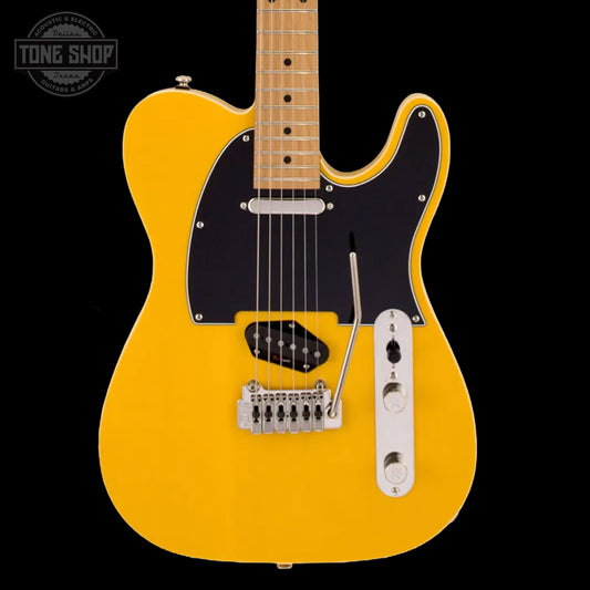 Yellow electric guitar with a black pickguard on a black background, featuring 'Tone Shop' branding.