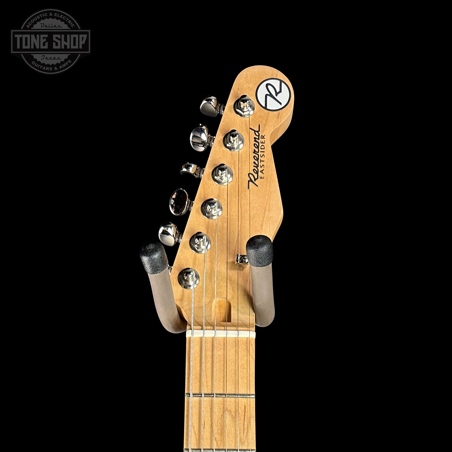 Guitar headstock with brand logo on a black background