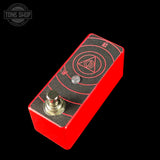 Red guitar effects pedal with black top on a black background, featuring the Tone Shop logo.