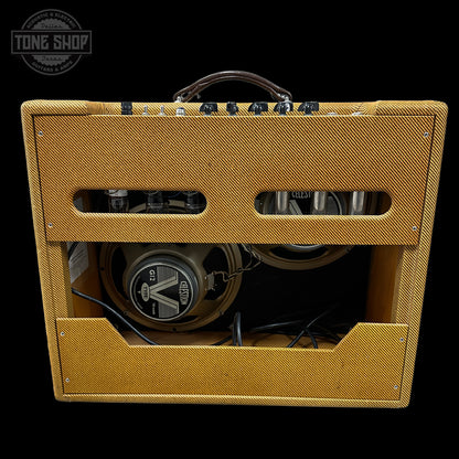 Yellow guitar amplifier with visible brand logo on a black background