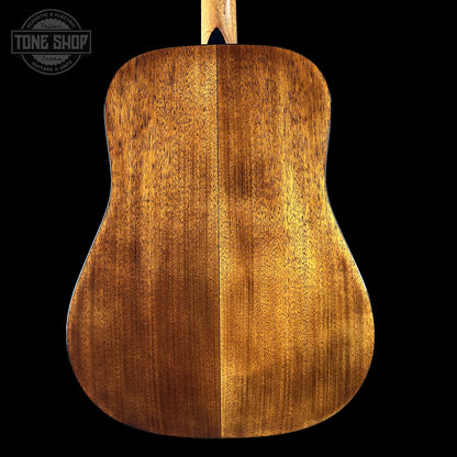 Back view of a wooden acoustic guitar with 'Tone Shop' logo.