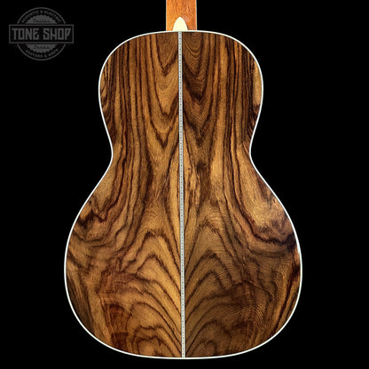 Wooden acoustic guitar back with 'Tone Shop' logo in the corner